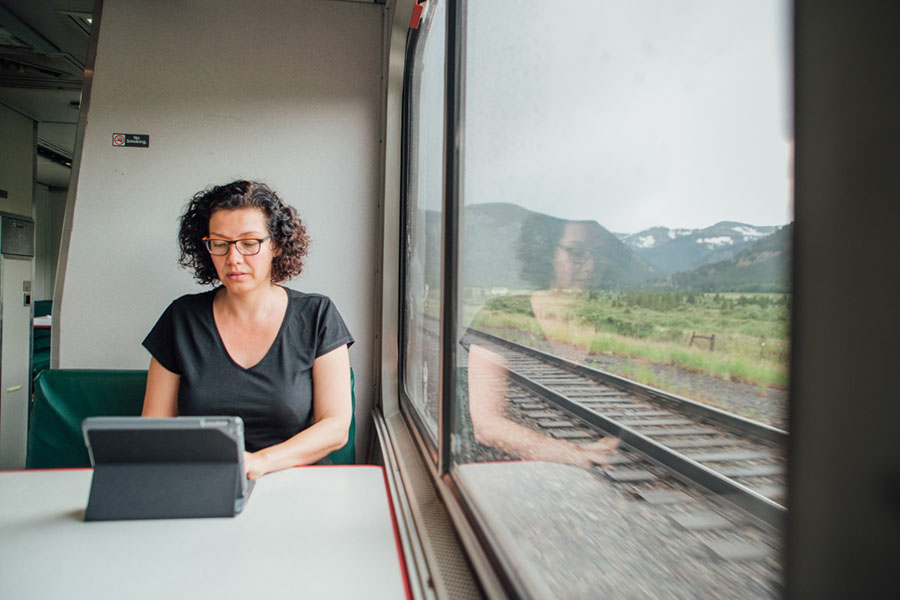 Woman enjoying free WiFi on Amtrak train cafe car